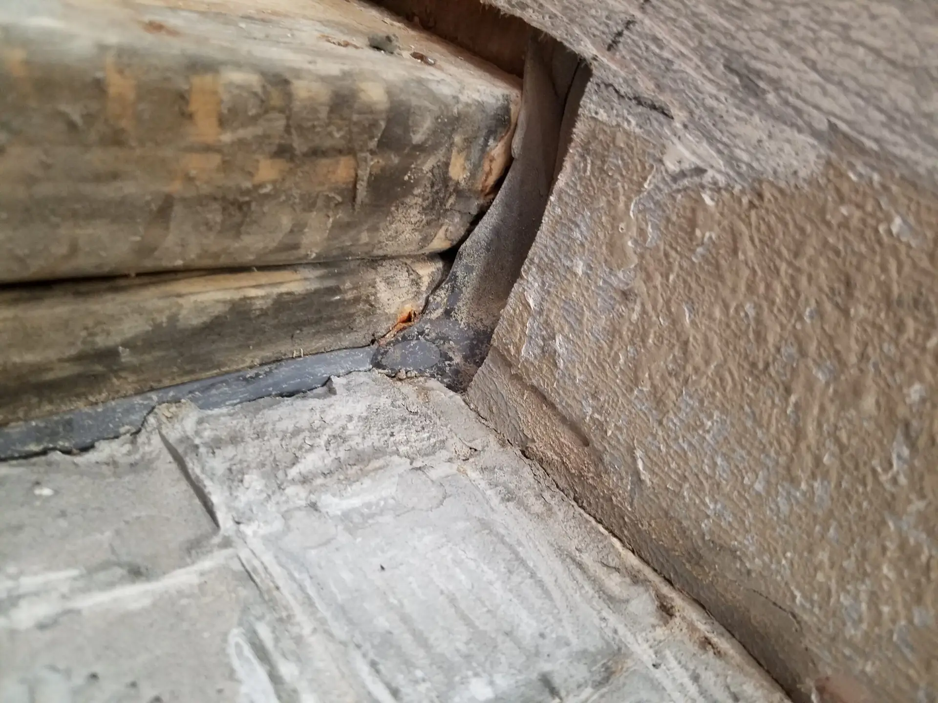 This picture shows that the Rubber membrain in this shower was cut to install the curb (the 2x4's. The cut membrain resulted in a major water leak . The builder left town prior to finishing his work and left the home owners to finish his work so they could move into the house they just bought. This home was built in 2019.